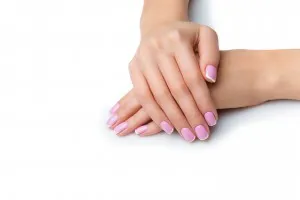Beautiful woman hands with french manicure. Isolated over white background. Copy space.